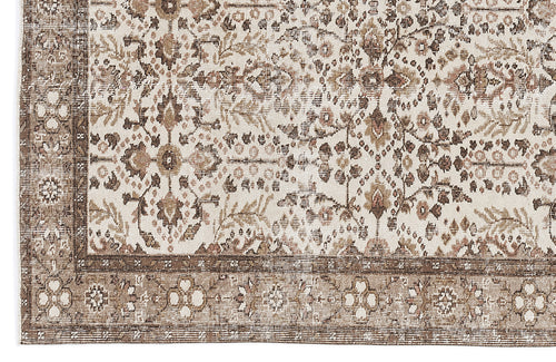 Load image 1 in gallery view. Cream and brown traditional rug with a distressed floral medallion pattern and a detailed border.