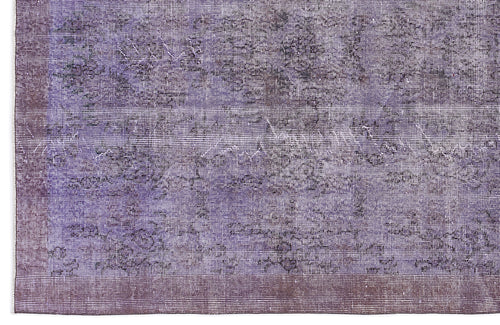 Load image 1 in gallery view. Purple and charcoal distressed vintage-style rug with a faded floral medallion pattern and a solid border.