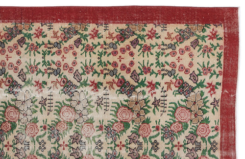 Load image 1 in gallery view. Beige rug with a red border and a repeating floral pattern in red, green, and grey on a white background.