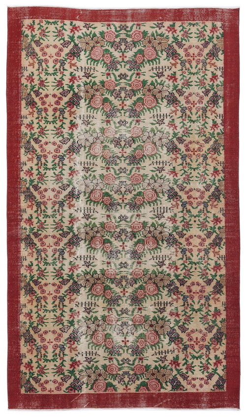Load image 1 in gallery view. Beige vintage-style rug with a red border and a repeating floral pattern in pink, green, and dark blue.