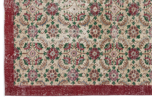 Load image 1 in gallery view. Beige rug with a distressed floral medallion pattern in red, green, and pink, featuring a solid red border.