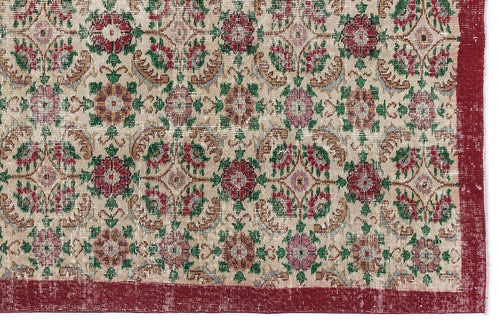 Load image 1 in gallery view. Beige rug with a repeating floral medallion pattern in red, green, and tan, featuring a solid red border.
