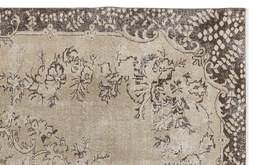 Load image 1 in gallery view. Beige and dark brown vintage-style rug with a distressed floral pattern and a decorative border.