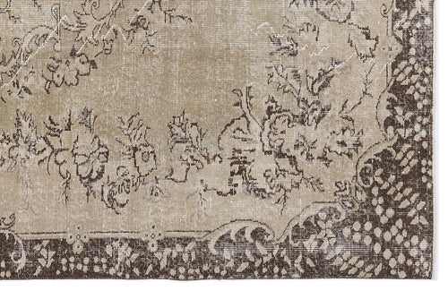 Load image 1 in gallery view. Distressed beige and dark brown rug with a traditional floral medallion pattern and a wide decorative border.