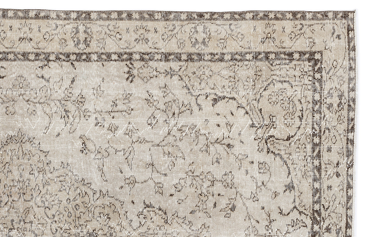 Beige and brown traditional rug with a distressed floral medallion pattern and a detailed geometric border.