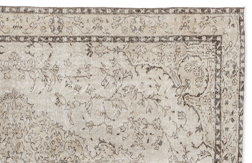 Load image 1 in gallery view. Beige and brown traditional rug with a distressed floral medallion pattern and a detailed geometric border.