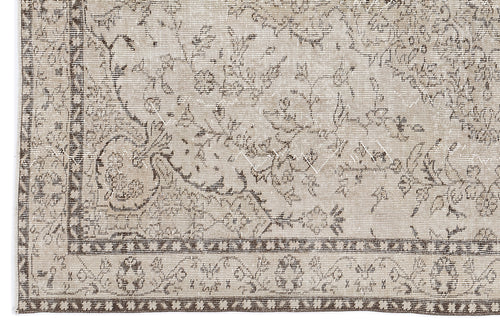 Load image 1 in gallery view. Beige and brown vintage-style rug with a distressed floral medallion pattern and a geometric border.