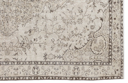 Load image 1 in gallery view. Beige and brown distressed rug with a traditional floral vine pattern and a geometric border.