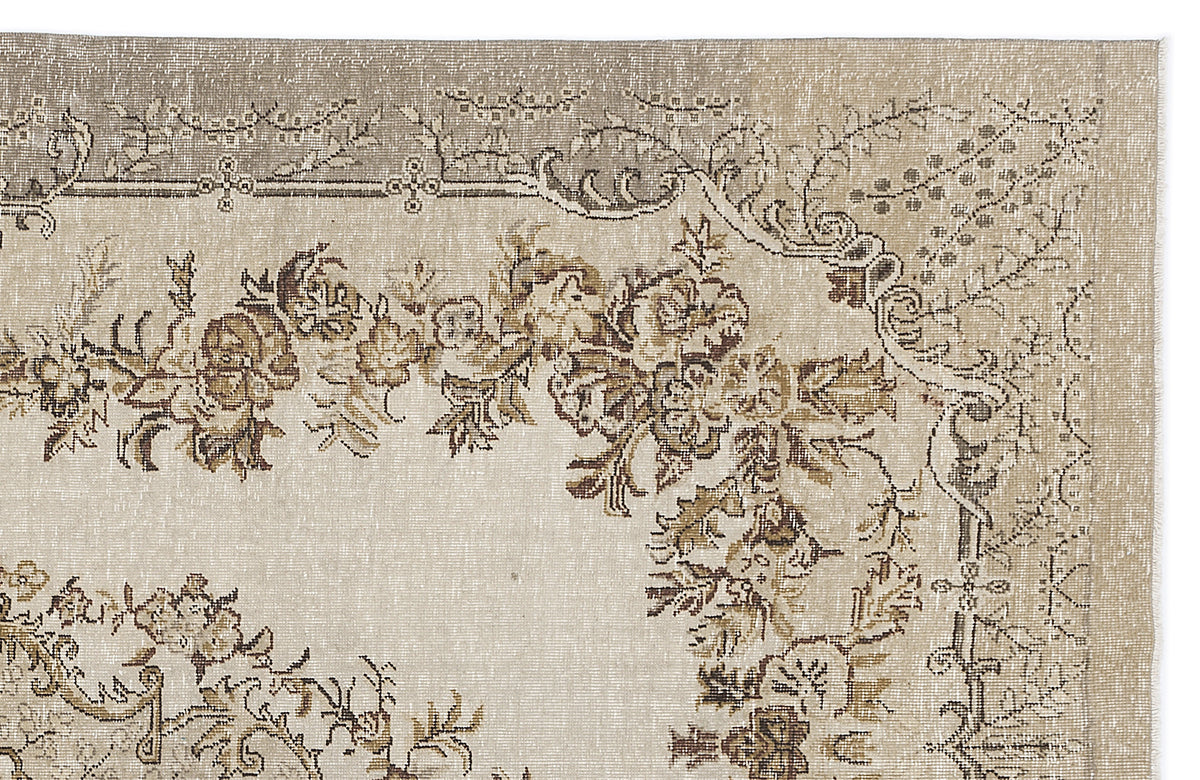 Beige and taupe vintage-style rug with a distressed floral medallion pattern and ornate border.