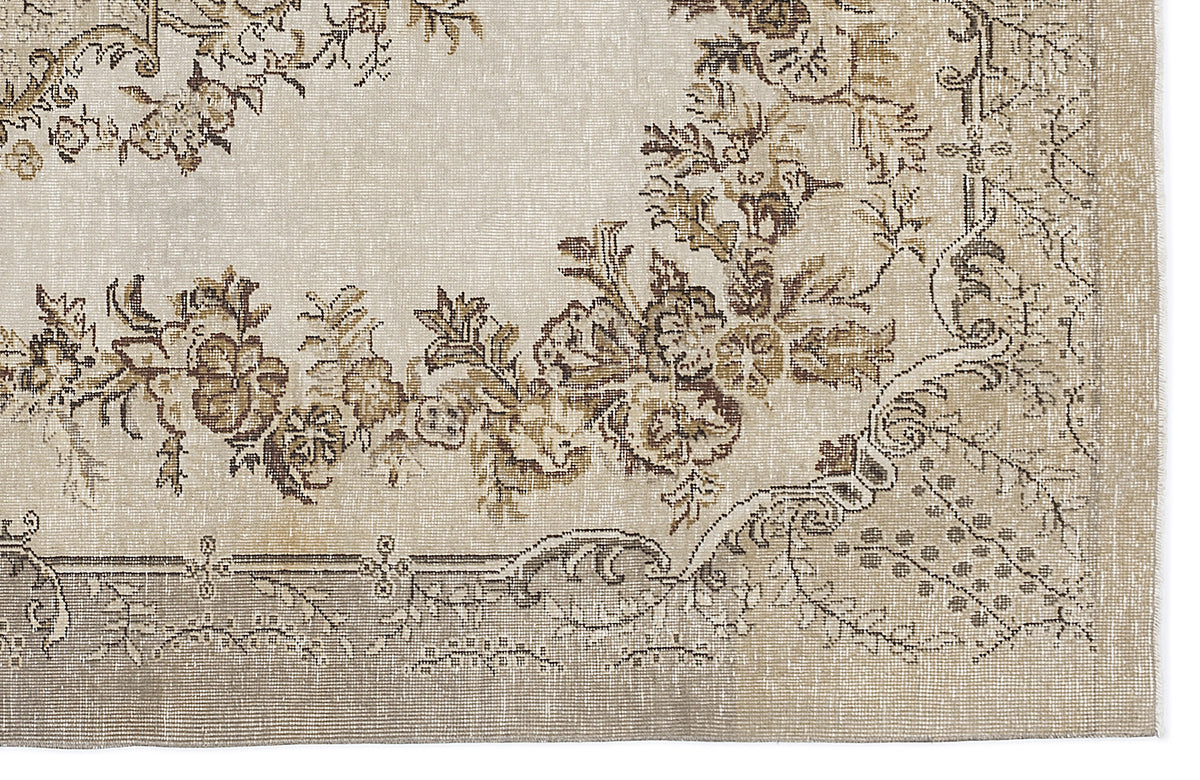 Beige and brown traditional rug with a distressed floral medallion pattern on a white background.