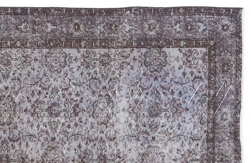 Load image 1 in gallery view. Distressed charcoal and light blue traditional rug with a floral medallion pattern and a wide decorative border.