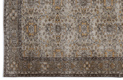 Load image 1 in gallery view. Distressed brown, grey, and ochre rug with a traditional floral medallion pattern and a wide decorative border.