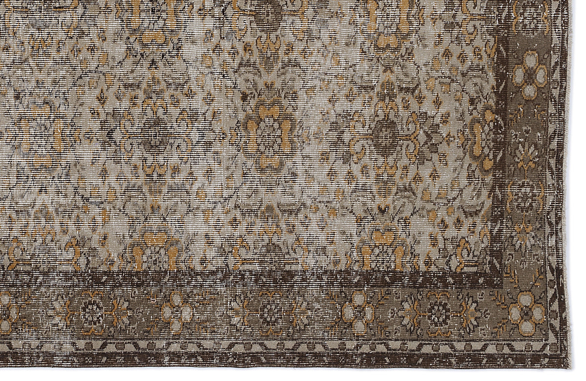 Distressed grey and ochre traditional medallion rug with a dark brown floral border on a white background.