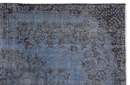Load image 1 in gallery view. Distressed slate blue rug with a dark charcoal floral medallion pattern and a detailed border.