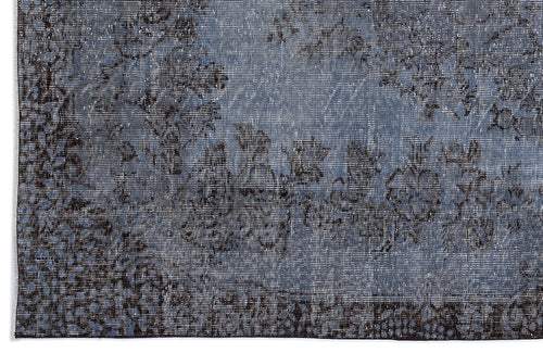 Load image 1 in gallery view. Blue and black distressed rug with a faded floral medallion pattern.