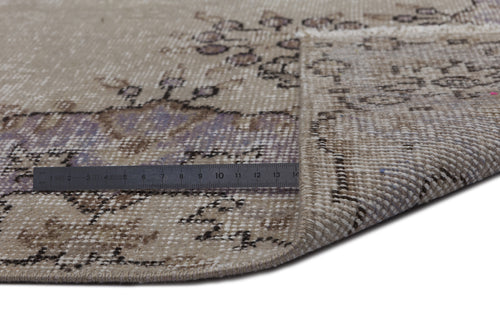 Load image 1 in gallery view. Beige and lavender distressed vintage rug with a floral medallion pattern, shown with a metal ruler for scale.