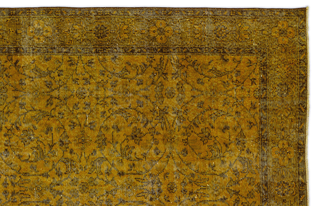 Mustard yellow and dark brown vintage-style rug with a traditional floral border and central medallion pattern.