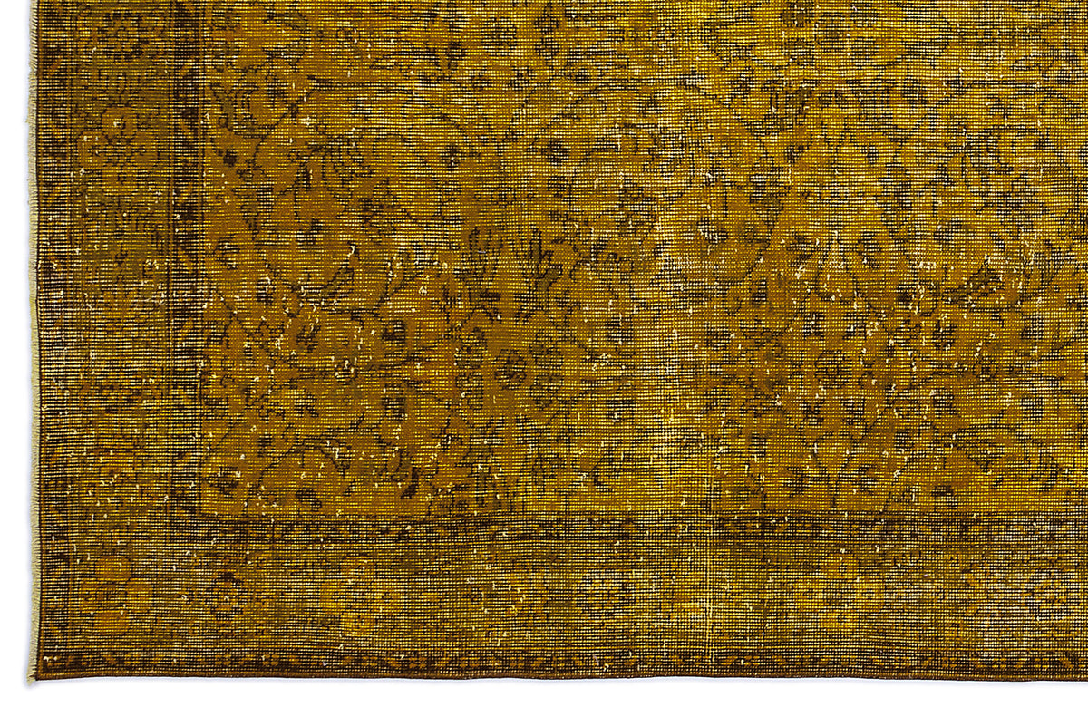 Mustard yellow distressed rug with a traditional floral medallion pattern and a bordered edge.