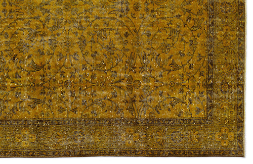 Load image 1 in gallery view. Mustard yellow vintage-style rug with a dark brown floral medallion pattern and a distressed border.