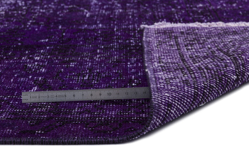 Load image 1 in gallery view. Deep purple distressed rug with a black abstract pattern and a folded corner showing the backing, measured by a ruler.