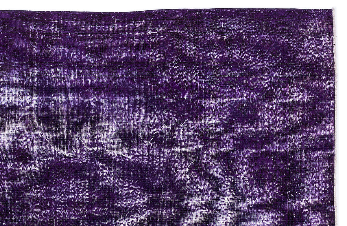 Deep purple vintage-style rug with a distressed, faded texture and white highlights.