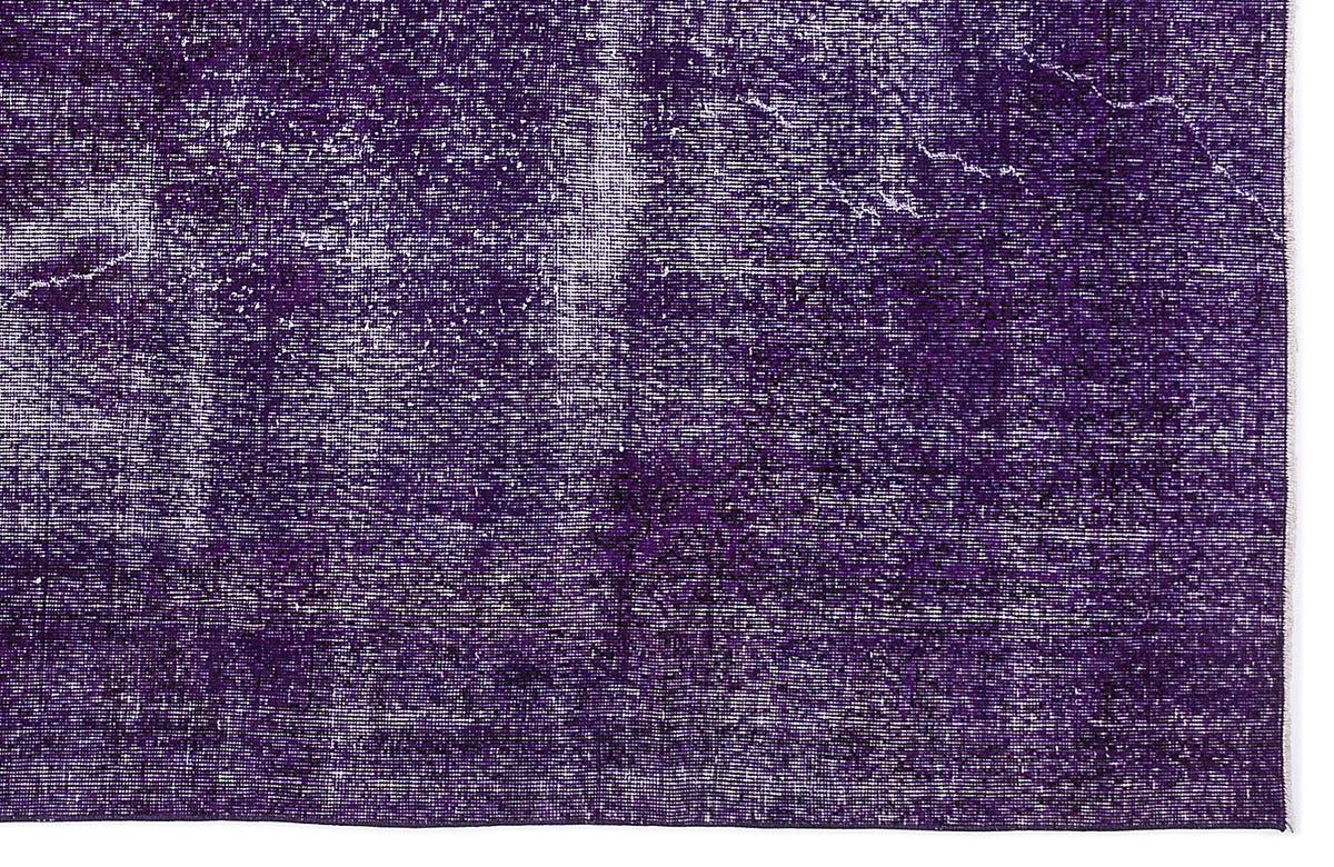 Deep purple rug with a distressed, weathered texture and white faded detailing.
