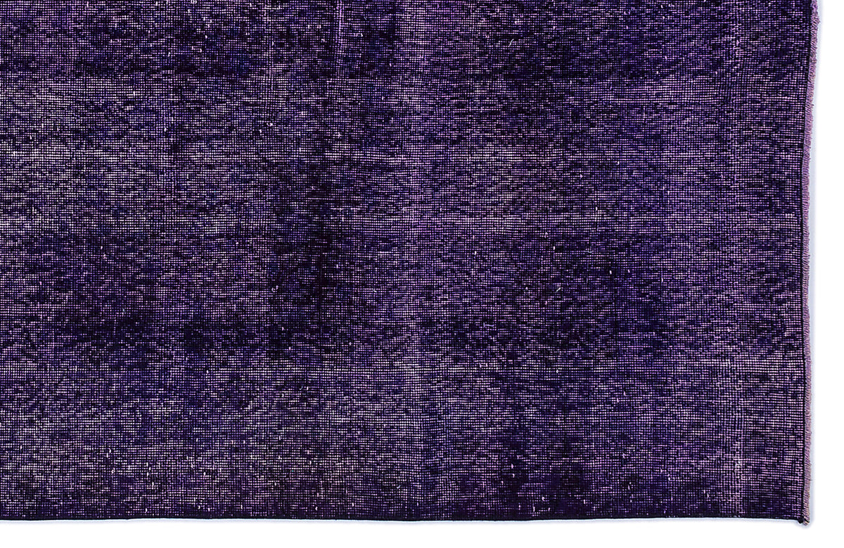 Deep purple distressed rug with a textured, monochromatic weave and frayed edge.