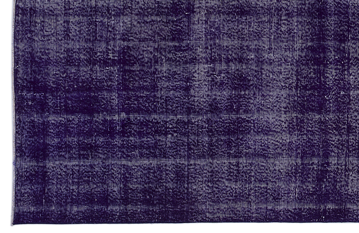 Deep purple vintage-style rug with a distressed, monochromatic texture and subtle grid pattern.