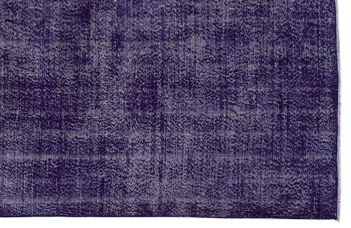 Deep purple distressed rug with a faded, monochromatic vintage texture on a white background.