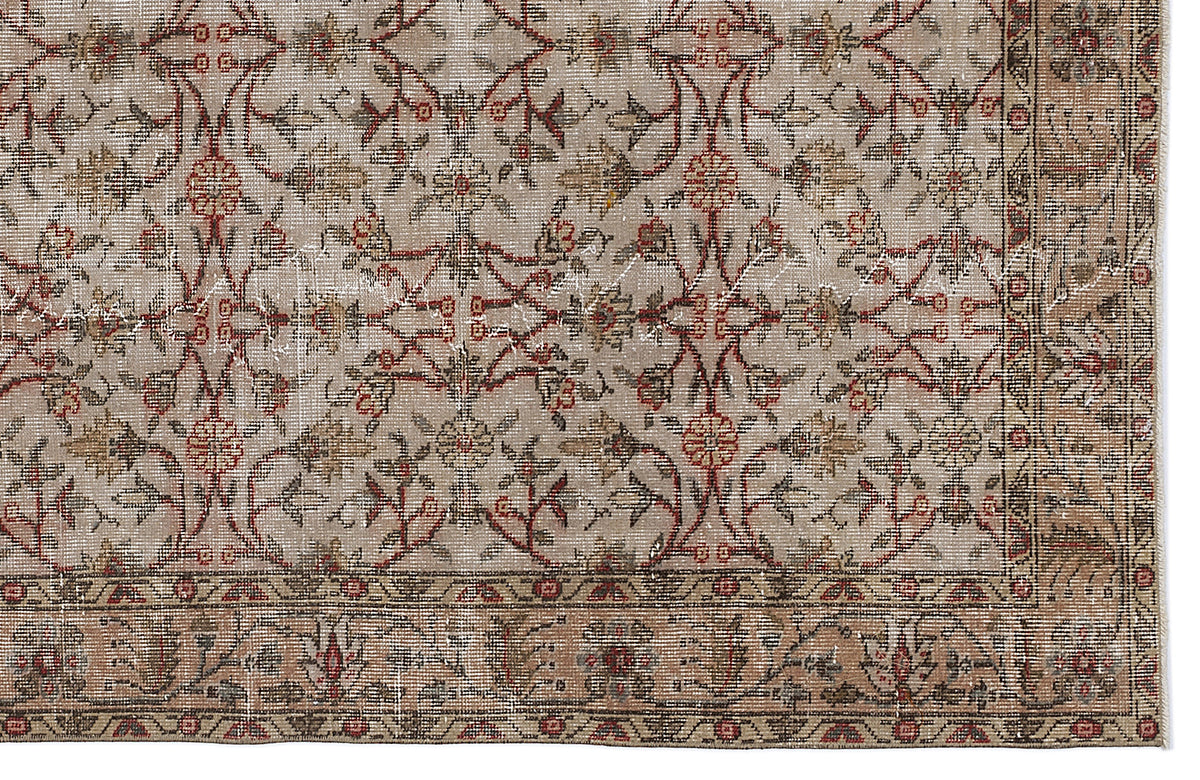 Beige vintage-style rug with a distressed floral vine pattern in red, brown, and cream, featuring a detailed border.