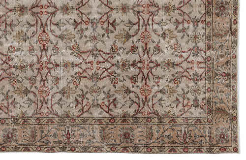 Load image 1 in gallery view. Beige vintage-style rug with a distressed floral vine pattern in red, brown, and cream, featuring a detailed border.