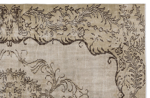 Load image 1 in gallery view. Distressed beige rug with a dark brown floral and vine pattern on a white background.