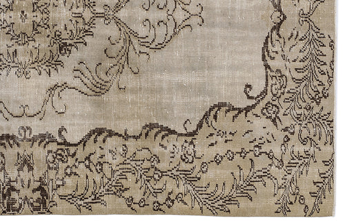 Load image 1 in gallery view. Beige and dark brown distressed rug with a traditional floral medallion pattern.