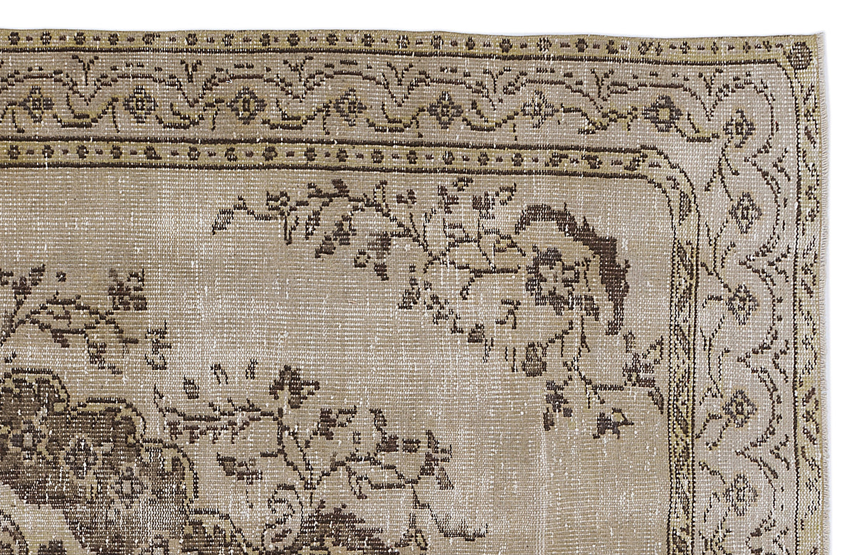 Beige and brown vintage-style rug with a distressed floral border and central vine motif on a white background.