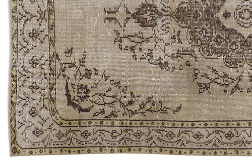 Load image 1 in gallery view. Distressed beige and brown rug with a traditional floral medallion pattern and an ornate geometric border.