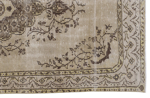 Load image 1 in gallery view. Beige and brown distressed rug with a traditional floral medallion pattern and an ornate decorative border.
