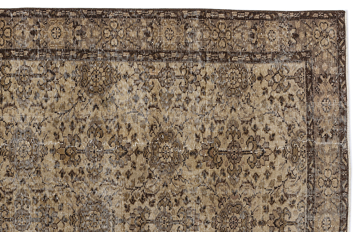 Dark brown and beige vintage-style rug with a distressed floral medallion pattern and a decorative border.
