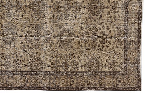 Load image 1 in gallery view. Brown and beige vintage-style rug with a distressed floral medallion pattern and a wide decorative border.