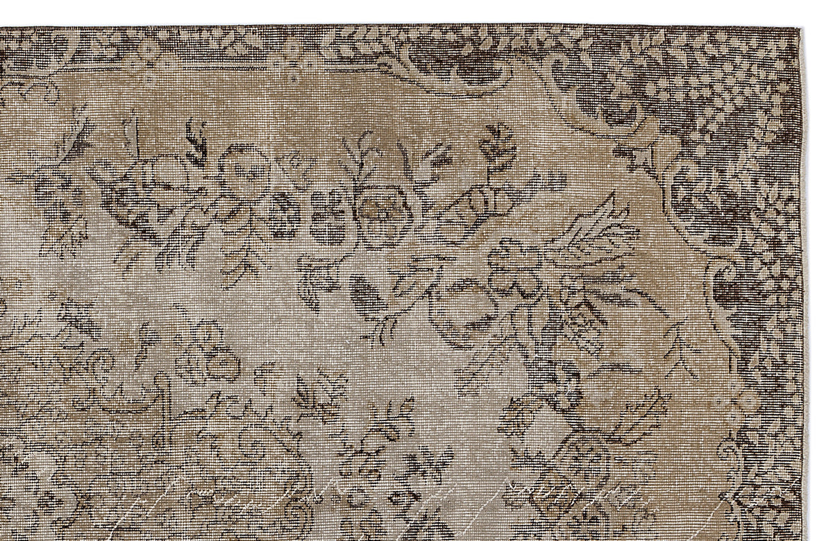 Distressed brown and beige vintage-style rug with a traditional floral medallion pattern.