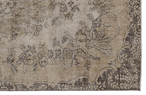 Load image 1 in gallery view. Distressed beige and dark brown rug with a faded floral medallion pattern.