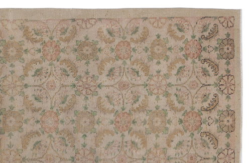 Load image 1 in gallery view. Beige vintage-style rug with a faded floral medallion pattern in muted pink, green, and tan tones.