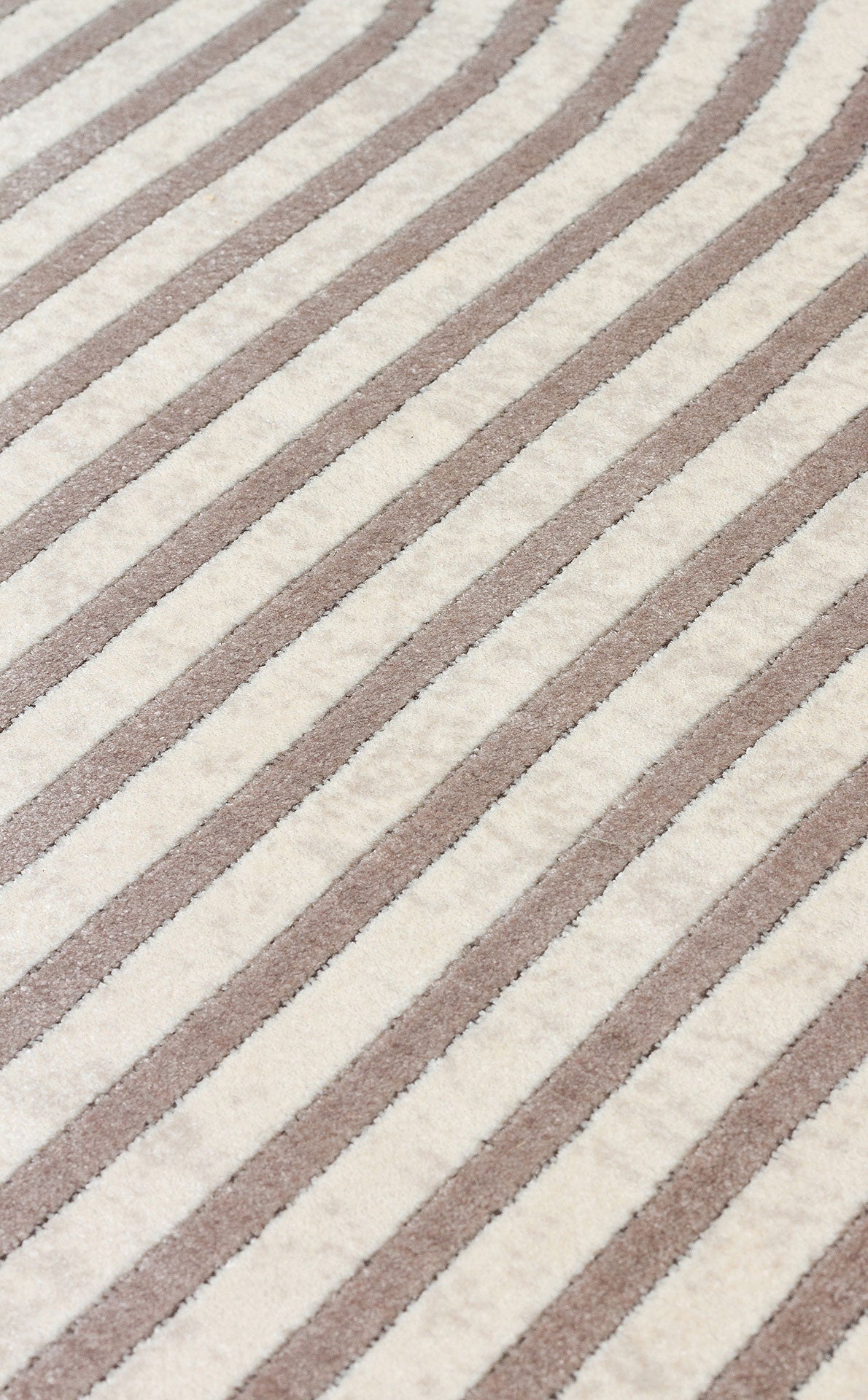 Cream and taupe rug with a repeating diagonal striped pattern and a textured pile.