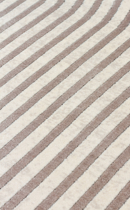 Load image 1 in gallery view. Cream and taupe rug with a repeating diagonal striped pattern and a textured pile.