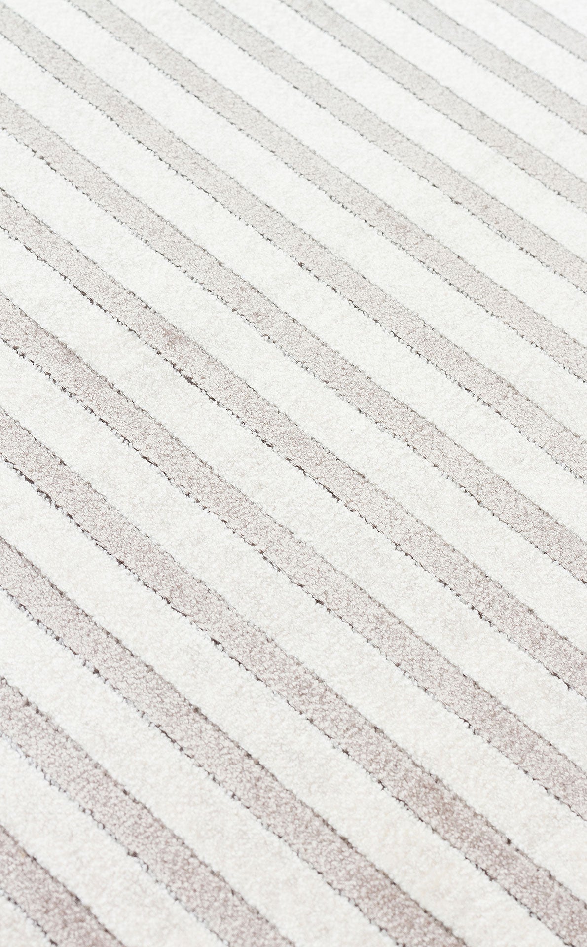 Off-white and light beige rug featuring a diagonal striped pattern with a textured, high-low pile.