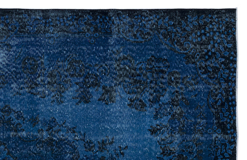 Load image 1 in gallery view. Deep blue and black distressed rug with a traditional floral medallion pattern.