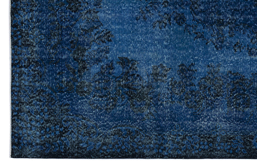 Load image 1 in gallery view. Deep blue and black distressed rug with a faded traditional floral medallion pattern.