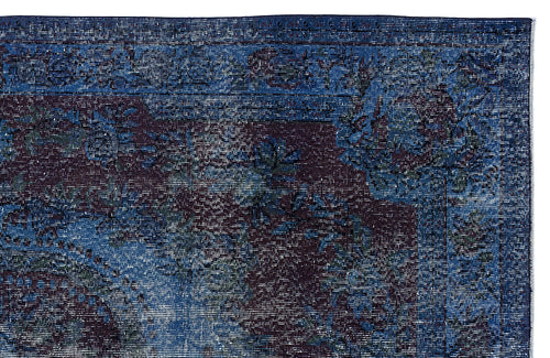 Load image 1 in gallery view. Deep blue and dark purple distressed rug with a traditional floral medallion pattern and a detailed border.