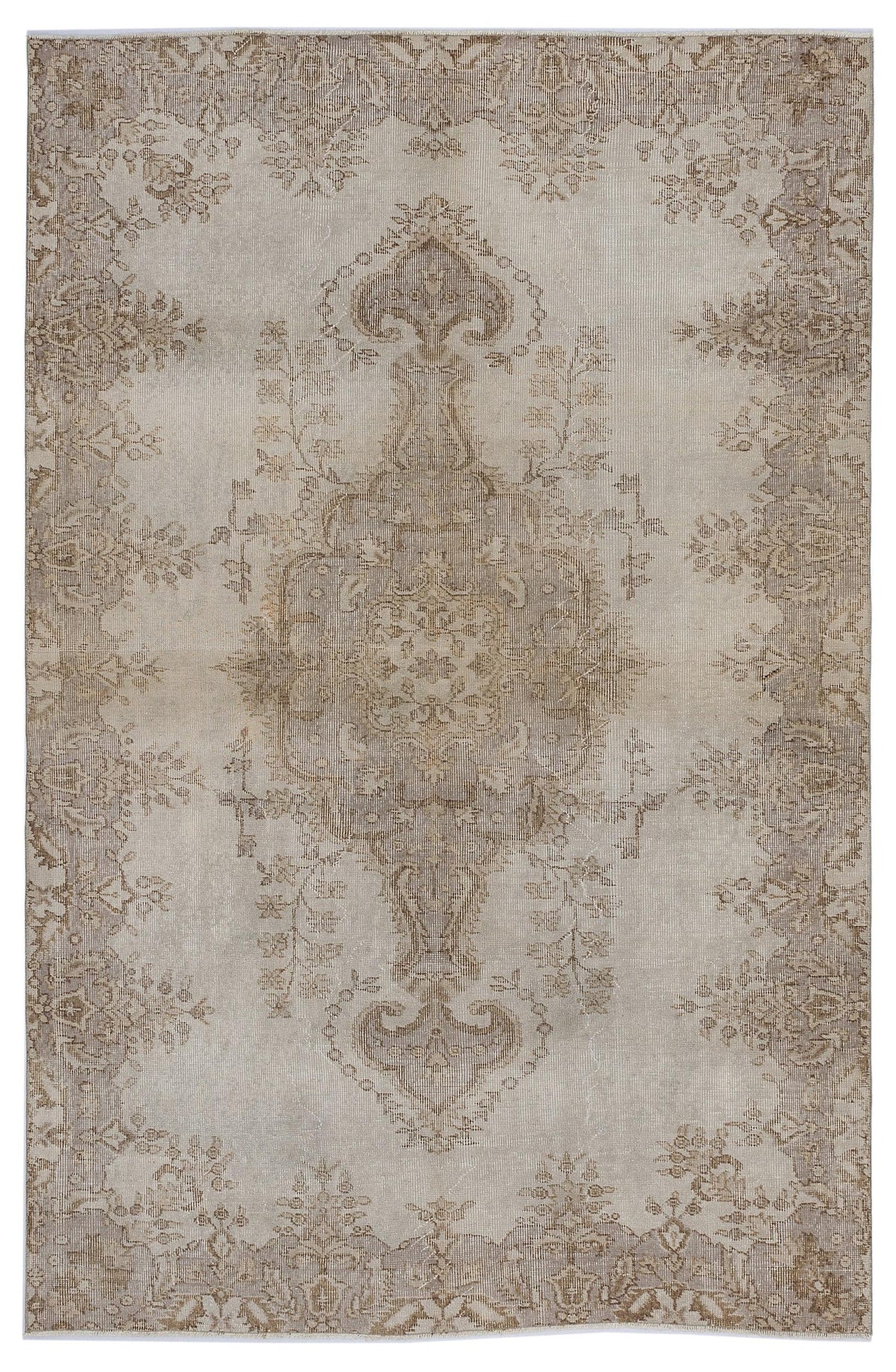 Beige and taupe distressed rug with a central floral medallion and ornate border pattern.