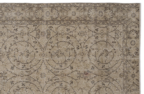 Load image 1 in gallery view. Taupe and brown vintage-style rug with a distressed floral medallion pattern and a decorative border.