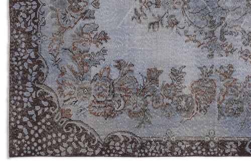 Load image 1 in gallery view. Distressed light blue rug with a dark brown floral border and central medallion pattern.